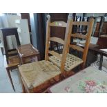 A pair of traditional beech ladder back chairs