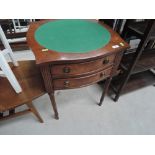 A reproduction Regency style chest of two drawers on legs with green baize top