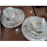 A Queen Anne tea for two and matching sandwich plates in gilt and white with floral decoration (11