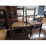 A pair of traditional stained frame bedroom chairs having bergere seats