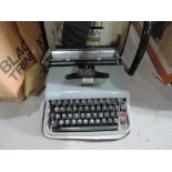 A vintage Ollivetti Lettera 22 typewriter in carry case
