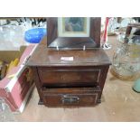A small wooden chest of two drawers and vintage photo frame