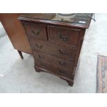 A reproduction Regency chest of two over three drawers of small proportions