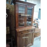 A Victorian mahogany book case having double cuoboard