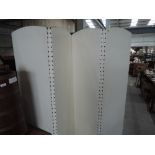 A folding room divider, cream leatherette