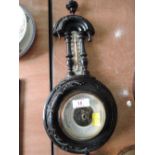 A carved Black Forrest style German barometer stamped 965