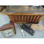 A treen souvenir box containing bone napkin rings, a Mauthe travel clock etc