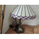 A Tiffany style lamp with bronze effect base