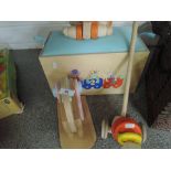 A wooden toy box, push along lion, and wooden toys