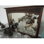 An oak frames bevel edged wall mirror with carved top