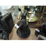 A bronze and ivorine style reproduction deco figurine, young lady seated