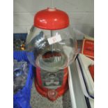 A retro sweet bubble gum dispenser coin operated style in red with glass dome