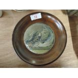 An early 20th century Prattware pot lid in wooden surround mount depicting a startled cat