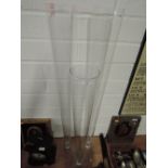Three tall slender glass vases two 100cm tall and one 80cm