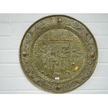 A large vintage brass plaque shield depicting a tudric tavern scene