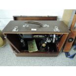 An antique singer sewing machine with case and crank handle no. EC151149