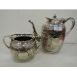 A Victorian Elkington plate teapot and sugar bowl having extensive repousse and engraved
