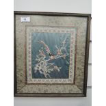 An oriental needle work on silk depicting bird of cherry blossom