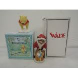 Two ceramic figurines a Royal Doulton Pooh bear and Wade Father Christmas catkins