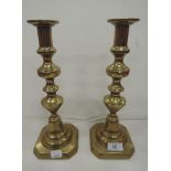 A pair of vintage brass bodied candle sticks