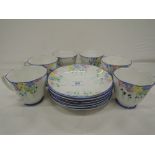 A part tea coffee service selection of plates and tea cups with hand painted art deco decoration