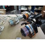 A selection of fishing and tackle related items including three large sea fishing reels