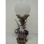 A novelty table top lamp in the form of a woodland fairy under moon