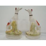 A pair of Staffordshire flat back style figurines as dogs possibly grey hounds