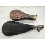 A black powder copper flask with game decoration, plus a leather shot flask including shot