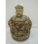 A vintage ceramic tea caddy in the form of a Chinese man made by Sadler