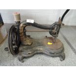 An early hand cranked cast metal sewing machine, possibly Jones.