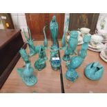 A selection of turquoise ceramic ornaments stamped with the initials AP and including serial