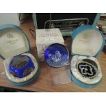 Three glass paperweights including two boxed Strathern glass and one Caithness