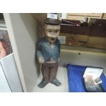 A large carved wood Charlie Chaplain figure in classic tramp outfit