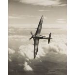 A SPITFIRE IN FLIGHT C. 1940s SOLD TOGETHER WITH A LARGE FORMAT SILVER PRINT PORTRAIT OF AN ARAB MAN