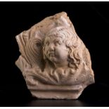 A Roman antefix with Eros1st century BC - 1st century AD; alt. cm 16; Part of an antefix decorated