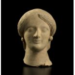 A refined portrait of a female Magna Graecia, early 5th century BC; alt. cm 12; A beautiful female