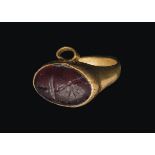 Small Roman gold finger ring with garnet Intaglio1st – 2nd century AD; diam. int. mm 11; gr 2,29;