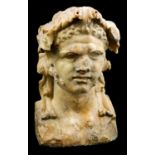 A Dionysian ancient yellow marble herm bust 1st century AD; alt. cm 18; An ancient yellow marble