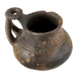 A charming clay jugEtruria, 9th – 8th century BC; alt. cm 9; A jug in brown clay with a flaring rim,