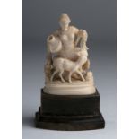 A carved ivory figure of a lady depicted while she feeds a deer - England, late 19th Century; ; on a