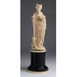 A carved ivory female figure - Germany / Holland, 19th Century; ; on a wood and ivory base. 27.3 cm,