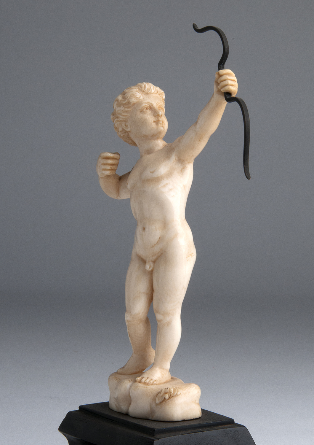 “Cupid”. A carved ivory figure depicting Cupid while shooting an arrow - France, 19th Century; ; - Image 3 of 5