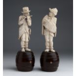 A pair of carved ivory figures of street musicians - Germany, late 19th Century; ; on a wooden