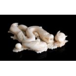 A carved coral sculpture depicting two dragons - China, 20th Century (pre-1947), 13.2 x 9.5 cm,