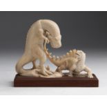 A carved ivory figural group depicting two dinosaurs - probably China, early 20th Century (pre-