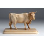 A carved ivory cow - probably England, early 20th Century (pre-1947); ; on ivory base, 9.6 cm, 3