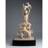 A carved ivory figural group of hunter holding a fox and his three dogs - England, 19th Century; ;