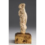 A carved ivory nude female figure - France, 19th Century; ; on a gilded wood base. 16.2 cm, 6 3/8 in