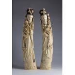 A pair of carved ivory figures of Guanyin holding peonies and wearing layered robes - China, late